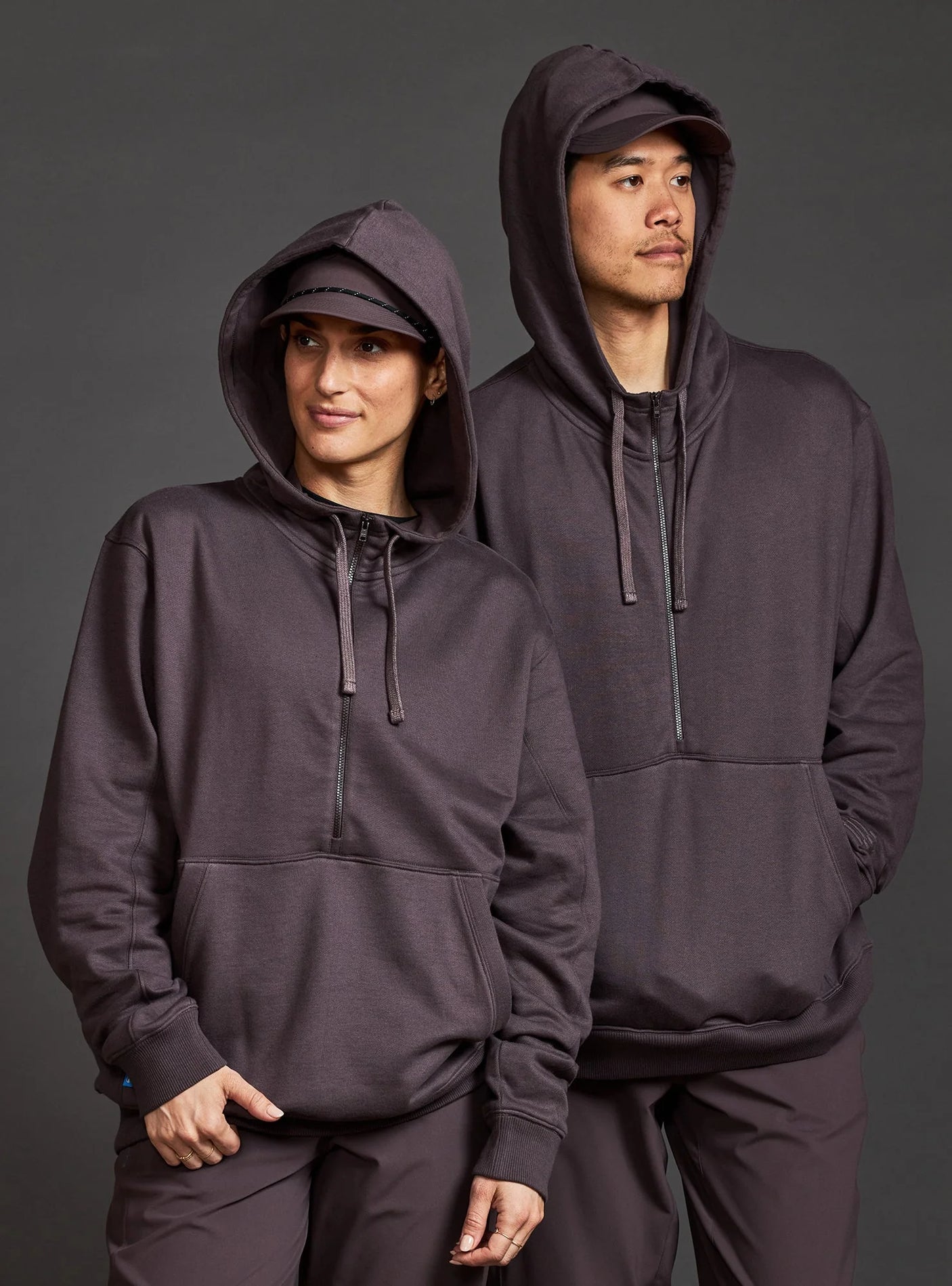 Janji Unisex Runaround Half-Zip Hoodie in Loam from the front being worn on a neutral background.