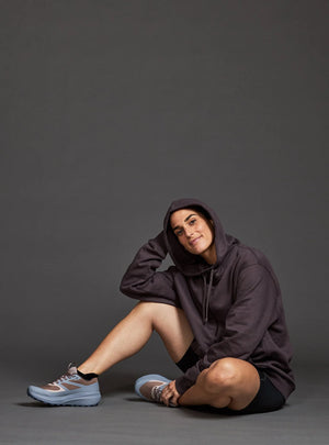 Janji Unisex Runaround Half-Zip Hoodie in Loam from the front being worn on a neutral background.