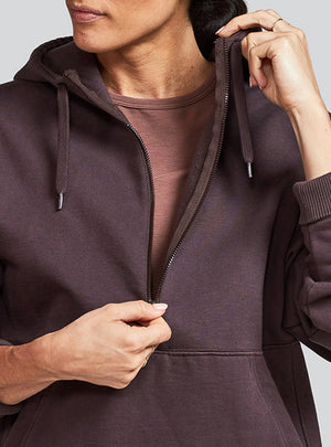 Janji Unisex Runaround Half-Zip Hoodie in Loam from the front being worn on a neutral background.