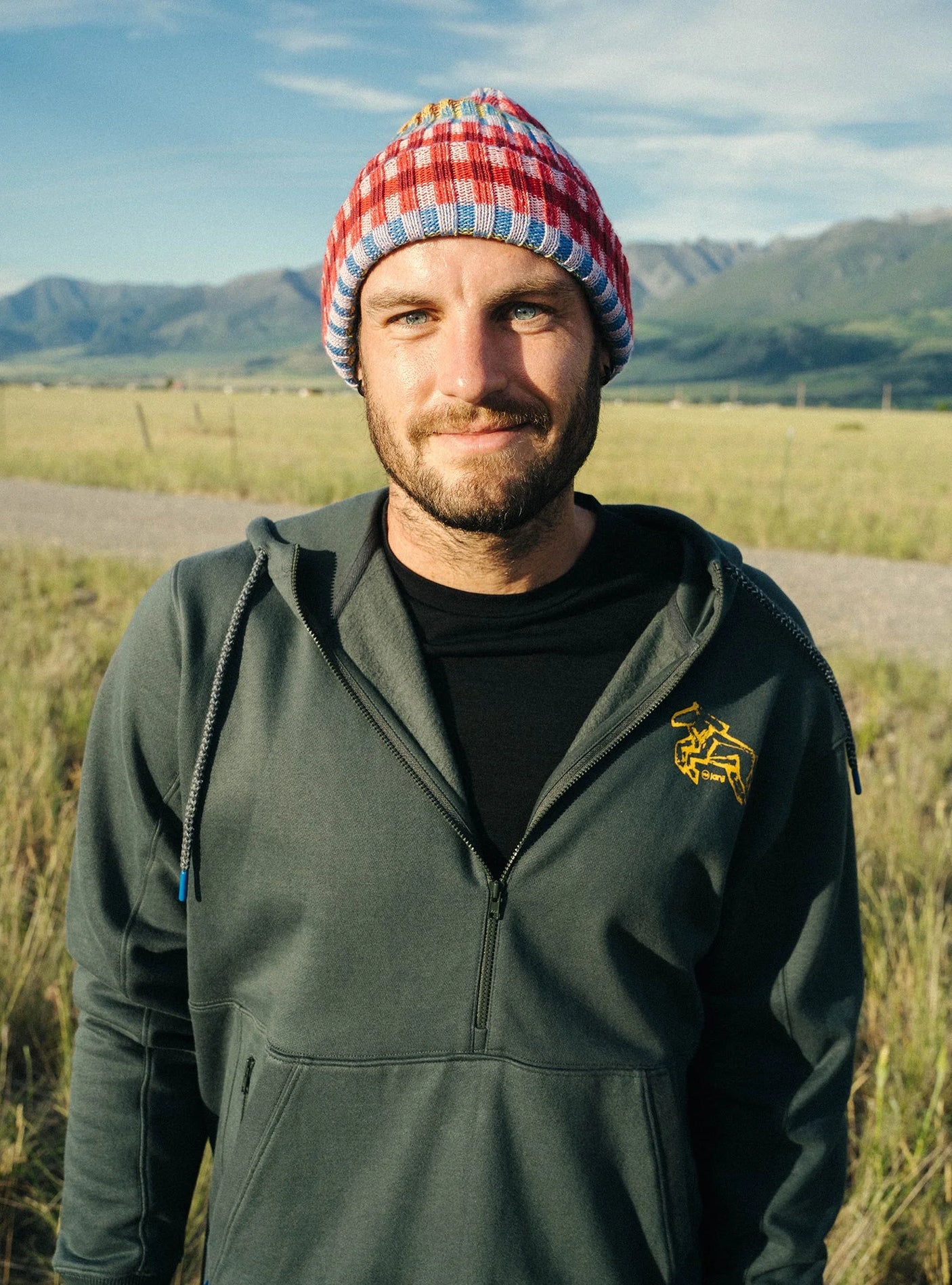 Janji Unisex Runaround Half-Zip Hoodie in Ridgeline Wild Horse being worn outdoors.