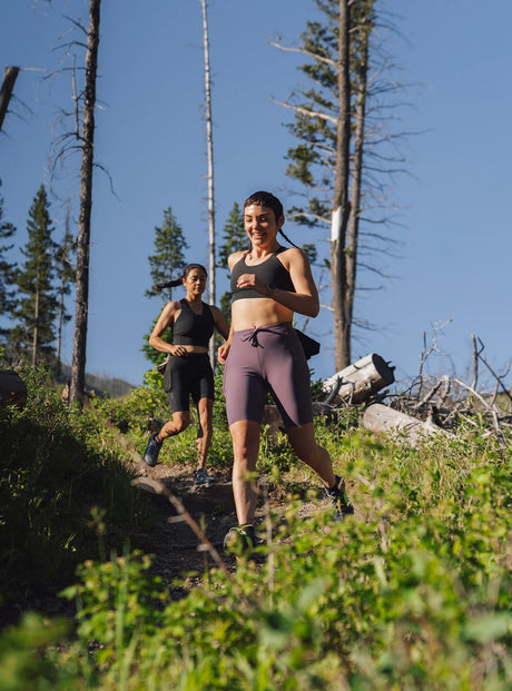 Janji W's 9" Trail Half Tight in Massif worn on a run outside.