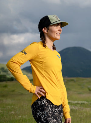 Janji W's Run All Day Long Sleeve in Golden Blue Horses worn by a woman outside.