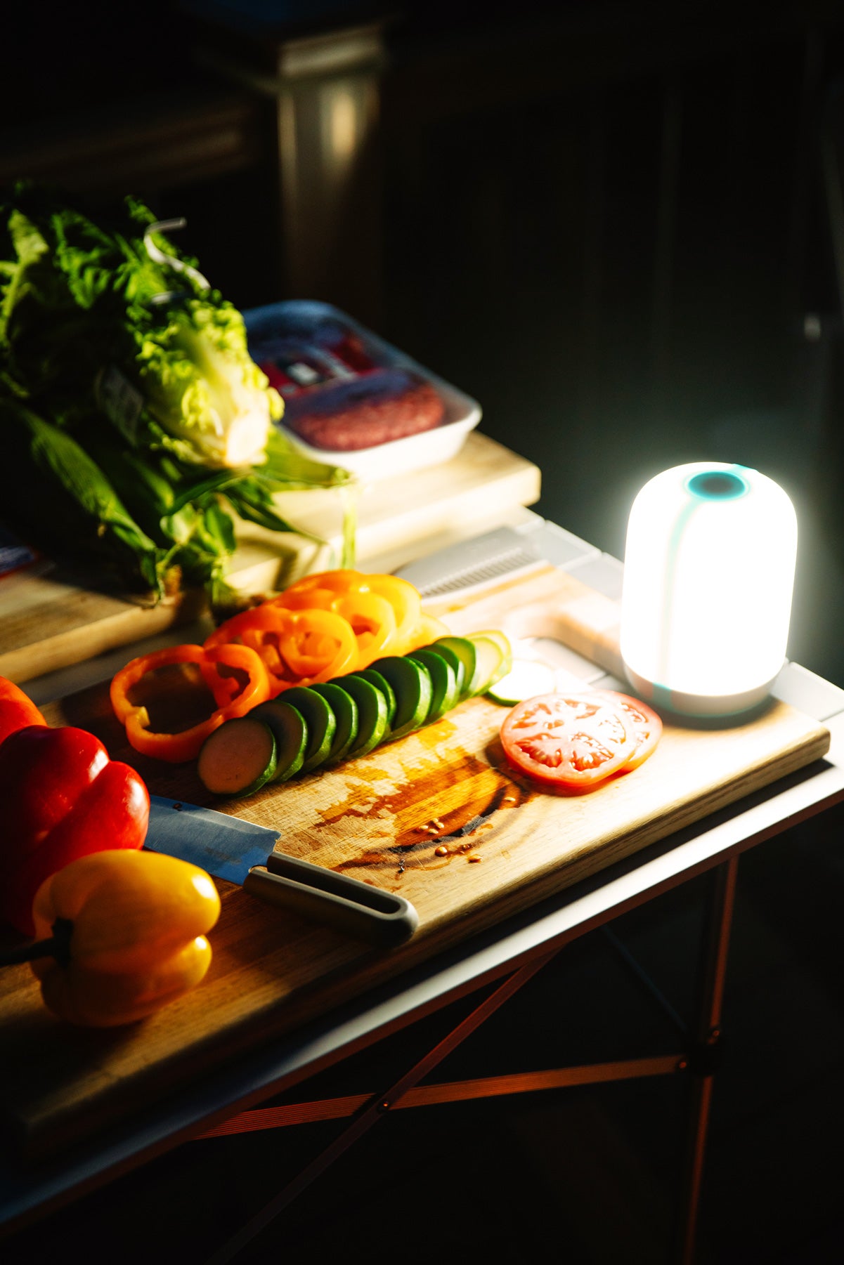 BioLite AlpenGlow 500 Lantern illuminating a camp cook table.