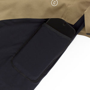 Close-up of a black pocket on a Ciele Athletics Men's DLYShort 5" 2-in-1 Running Short in Canvas Beige with a white background
