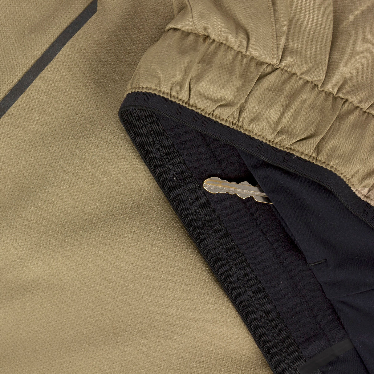 Close-up of Ciele Athletics Men's DLYShort 5" 2-in-1 Running Short in Canvas Beige hidden key pocket