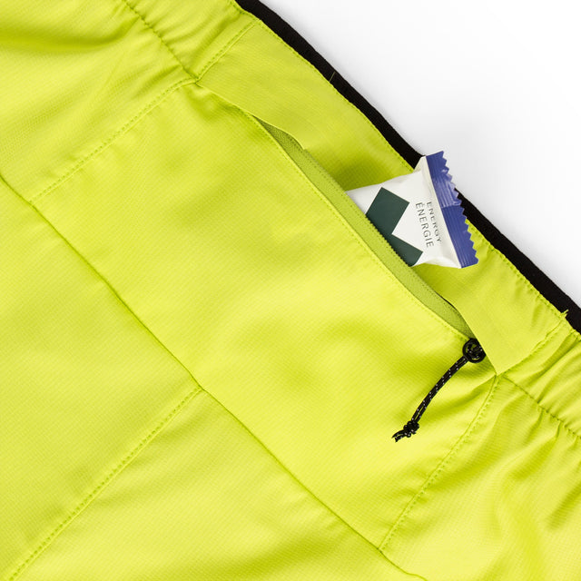 Close-up of a Ciele Athletics Men's DLYShort 5" 2-in-1 Running Short in Lime Green with zipper pocket