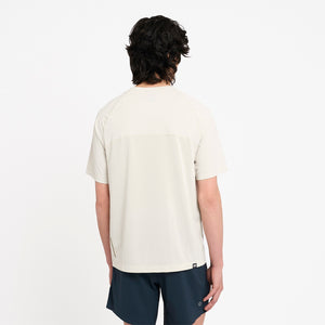 Person wearing a Ciele Athletics men's DLYTshirt Running Shirt in Rainy Day and navy shorts on a white background