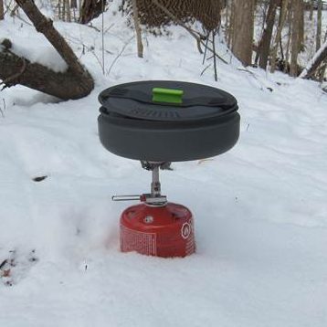 SOTO Amicus Stove with Igniter outdoors in the snow.