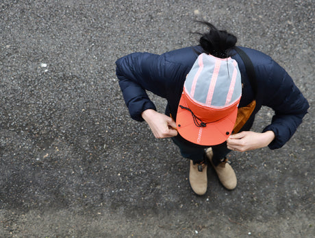 Parapack P-Cap Lite lightweight hat in Redrock worn by a woman outside.