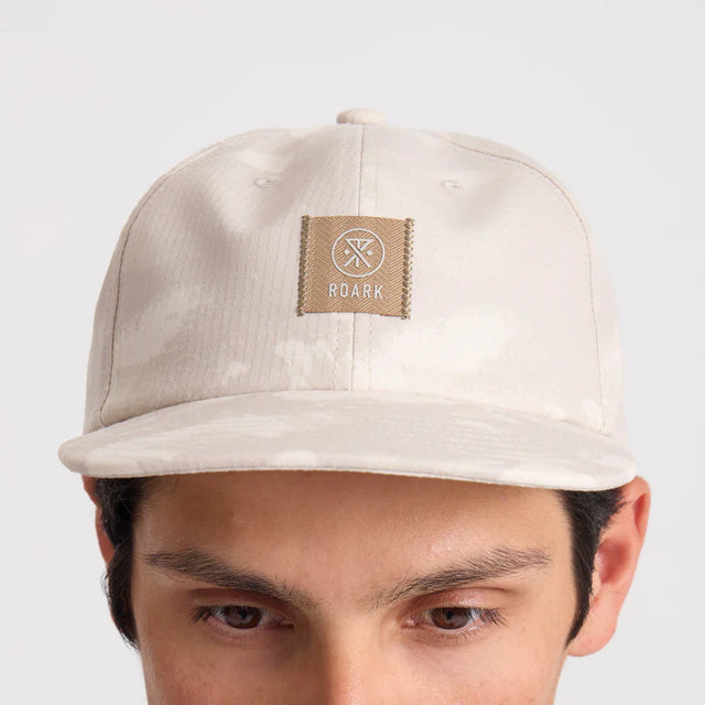 Roark Bless Up Trail Hat Strapback Hat in Fossil with a brand logo on a white background