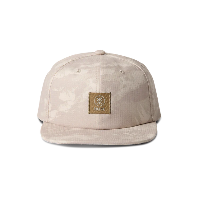 Roark Bless Up Trail Hat Strapback Hat in Fossil with a brown patch on a white background