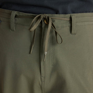 Close-up of Roark Layover Pro Traveler Pants in Military with a drawstring waistband.