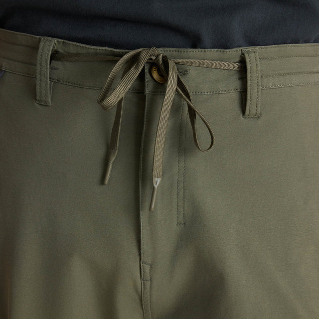 Close-up of Roark Layover Pro Traveler Pants in Military with a drawstring waistband.