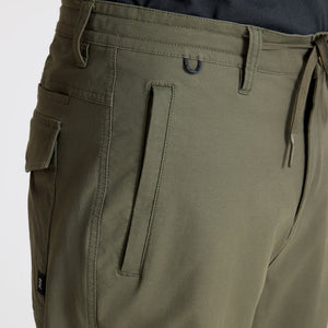 Close-up of Roark Layover Pro Traveler Pants in Military with a white background