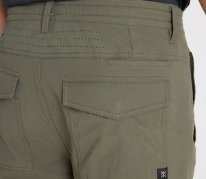 Close-up of Roark Layover Pro Traveler Pants in Military with a visible brand logo on a white background