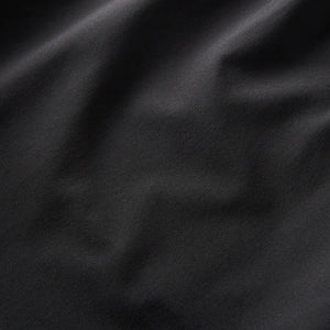 Close-up of Roark Serrano 7" Active Stretch Shorts in Black fabric texture