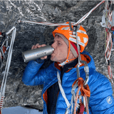 SOTO Titanium Bottle 300ml, ultralight bottle outdoors being used by a rock climber.