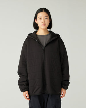 Person wearing a Snow Peak Flexible Insulated Zip Up Hoodie in Black on a plain background