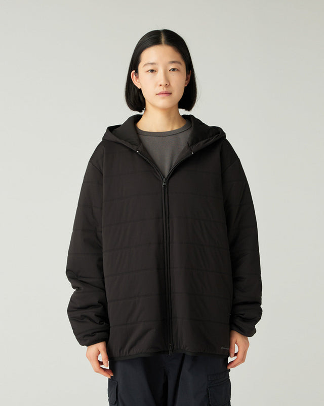 Person wearing a Snow Peak Flexible Insulated Zip Up Hoodie in Black on a plain background
