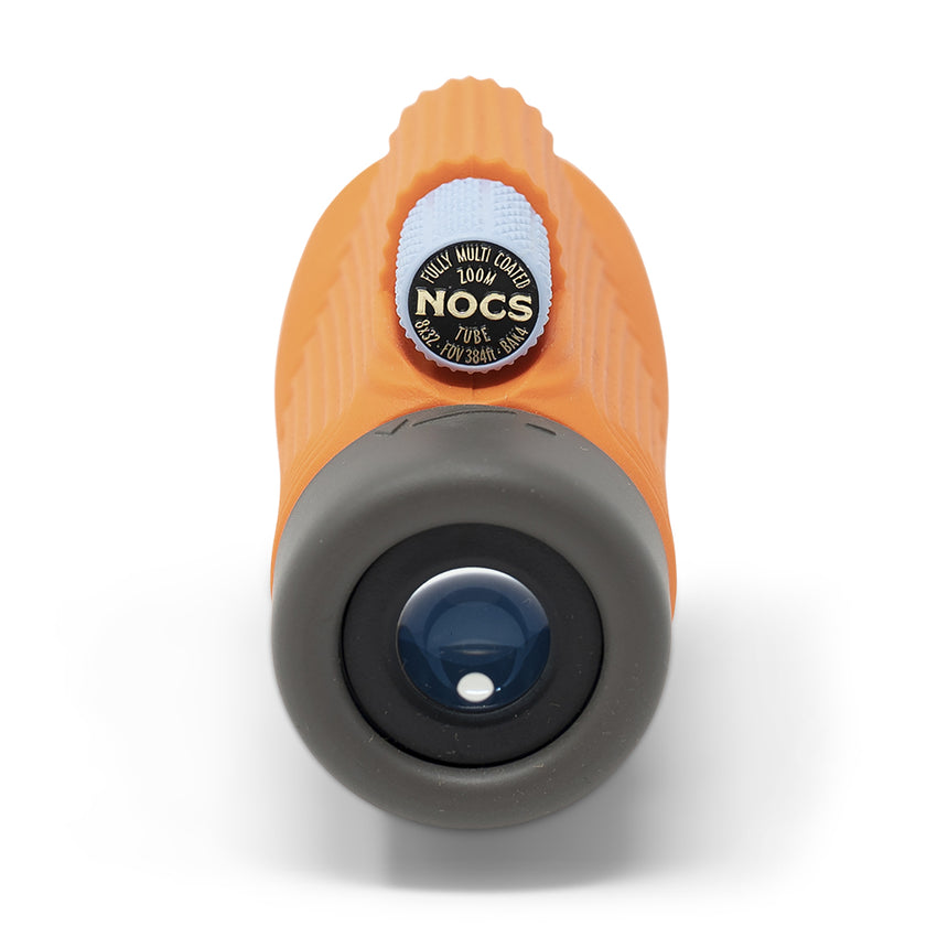 Nocs Provisions Zoom Tube 8x32 Monocular in International Orange on a neutral background showing the eye piece.