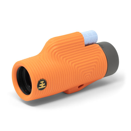 Nocs Provisions Zoom Tube 8x32 Monocular in International Orange on a neutral background.