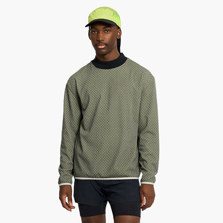 Person wearing a ciele athletics VLVMockneck Fleece Running Sweatshirt in Glade and black shorts on a white background