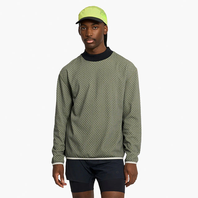 Person wearing a ciele athletics VLVMockneck Fleece Running Sweatshirt in Glade and black shorts on a white background