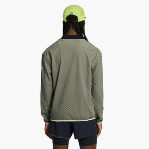 Person wearing a ciele athletics VLVMockneck Fleece Running Sweatshirt in Glade and black shorts with a white background