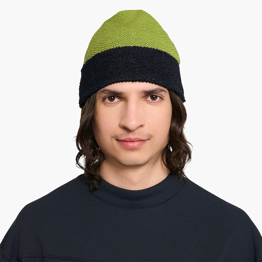 Person wearing a ciele UHBeanie fleece running beanie in Lime Green on a white background