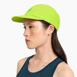 Woman wearing a Ciele Athletics GOCap Classic - Athletics Lime Green running cap on a white background