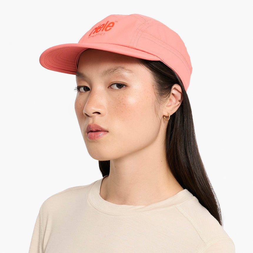 Person wearing a Ciele Athletics GOCap Classic - Athletics Blossom Coral running cap with 'hello' text on a white background