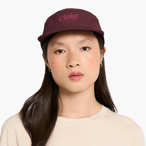 Person wearing a maroon ciele athletics GOCap Classic - Athletics in Dark Wine Red with 'Ciele Athletics' logo on a white background