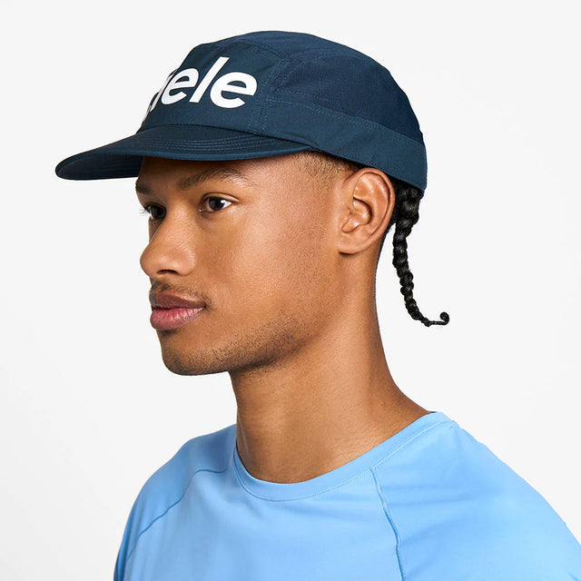 Person wearing a navy ciele athletics GOCap Comp - Century in Deep Space with 'ciele' logo on a white background