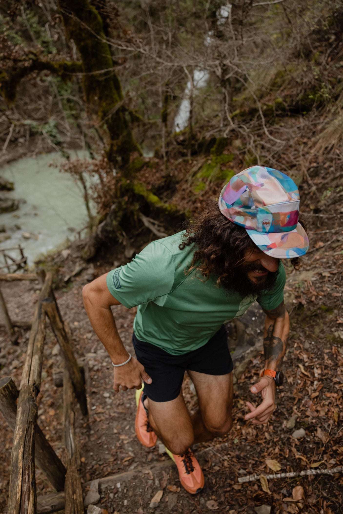 Janji AFO Hyperlight Cap worn by a man outdoors in the forest.