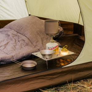 Snow Peak LiteMax Titanium Stove on a camping background.