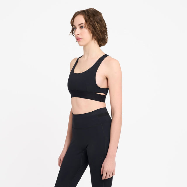 Ciele Athletics W QCKBra women's running bra in Shadowcast worn by a woman on a neutral background.