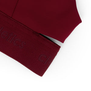 Close-up of a Ciele Athletics Women's QCKBra Sports Bra in Crimson Red Maroon sports bra on a white background