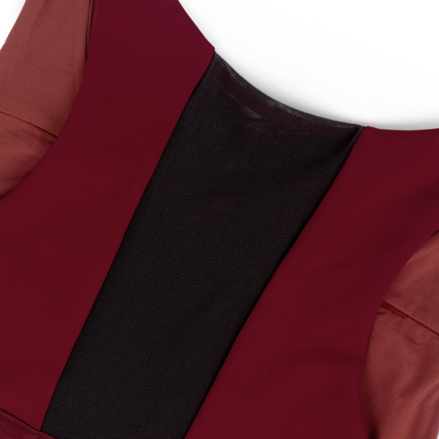 Close-up of a Ciele Athletics Women's QCKBra Sports Bra in Crimson Red Maroon sports bra with a black back vent on a white background
