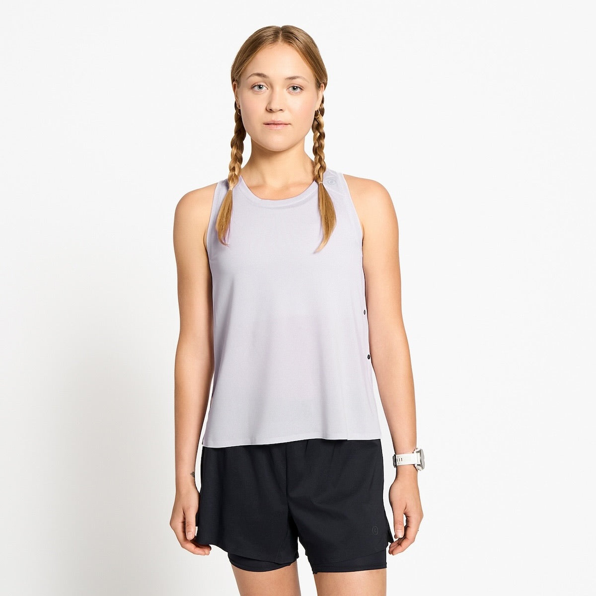 Ciele Athletics W FSTSinglet women's running tank top in Misty Lilac worn by a woman runner on a neutral background.