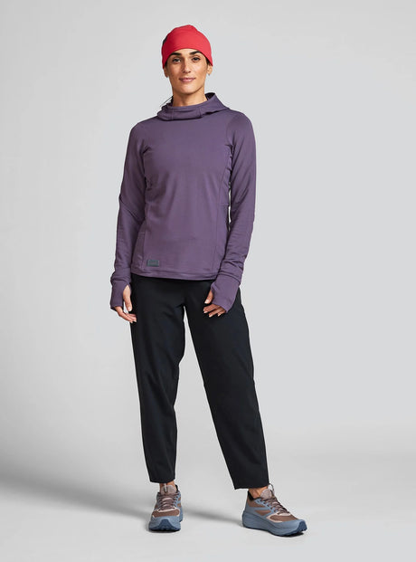 Janji W's Rover Merino Hoodie for women in Massif worn by a woman on a neutral background.