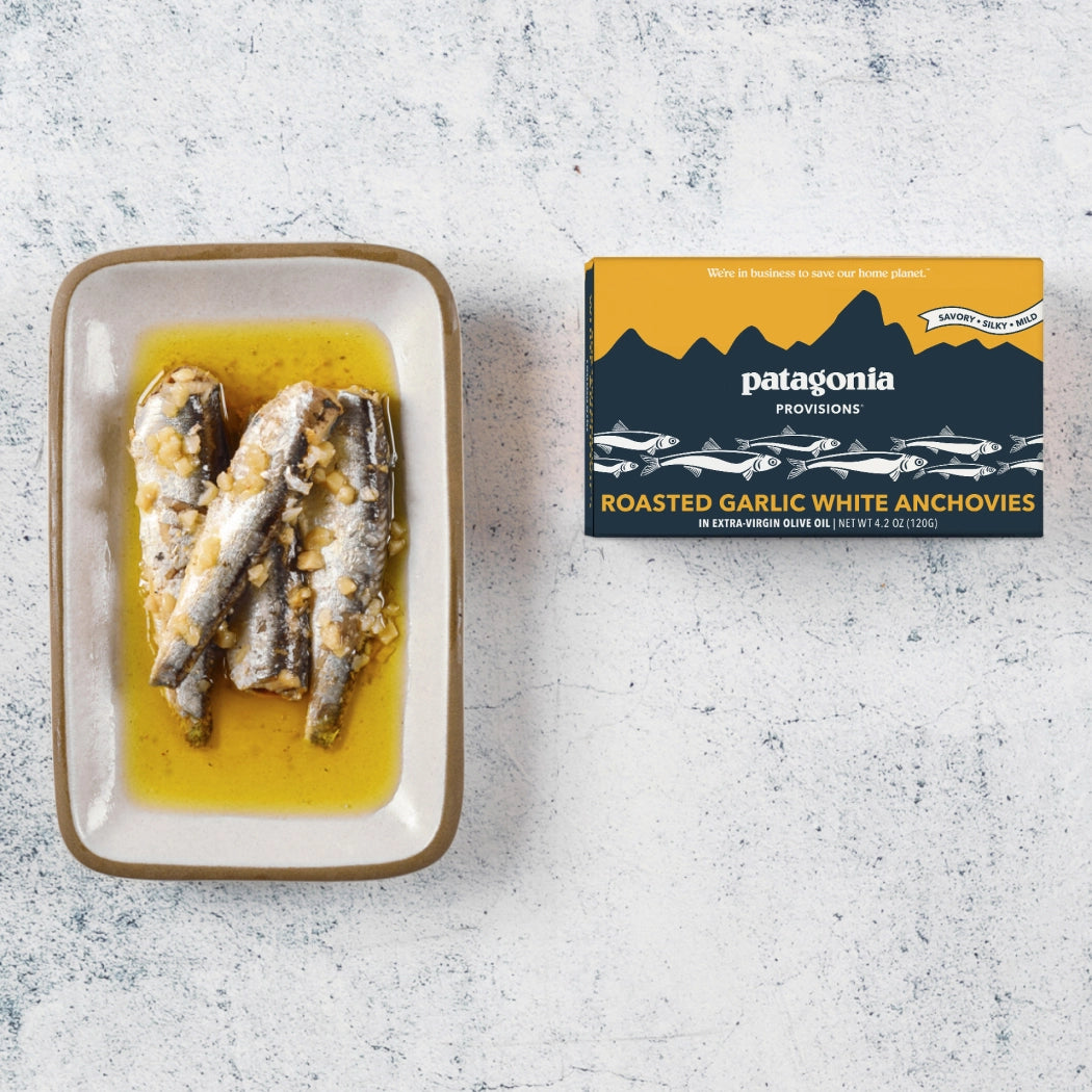 Patagonia Provisions roasted garlic white anchovies on a textured surface