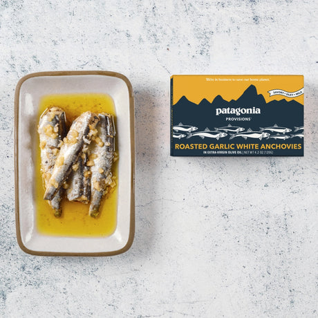 Patagonia Provisions roasted garlic white anchovies on a textured surface