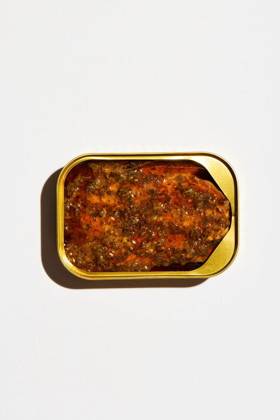 Fishwife Smoked Rainbow Trout with Red Chimichurri with gold tin on a white background