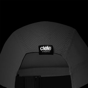 Ciele Athletics ALZCap - Athletics SL in Ghost on a dark background from the rear to show the reflective tag.