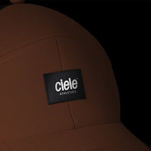 Ciele Athetics TRKCap SC - Box in Canyon from the front on a dark background showing the reflective detailing.