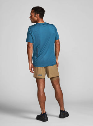 Janji Run All Day Tee on a neutral background being worn by a man and showing the back of the shirt.