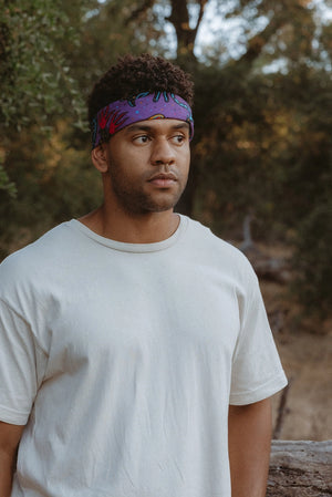 Bandits Electric Desert Parade bandana worn by a man outdoors.