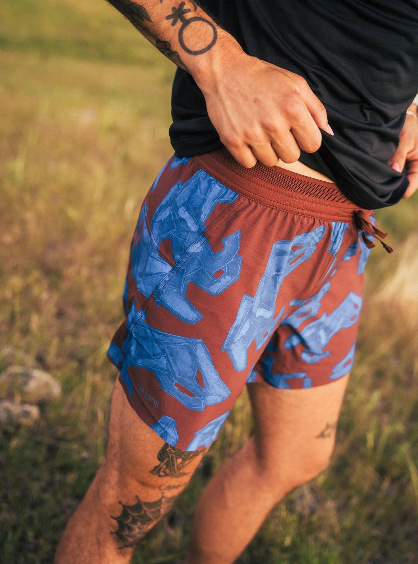 Janji Men's 5" AFO Middle Short in Cobalt Horses being worn outdoors.