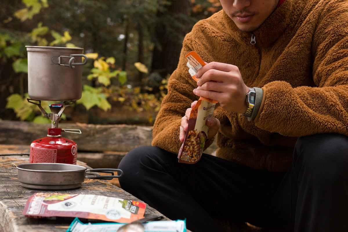 Camper cooking a meal outdoors.