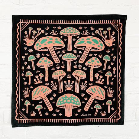 Land & She Field of Mushrooms Bandana on a neutral brick background.